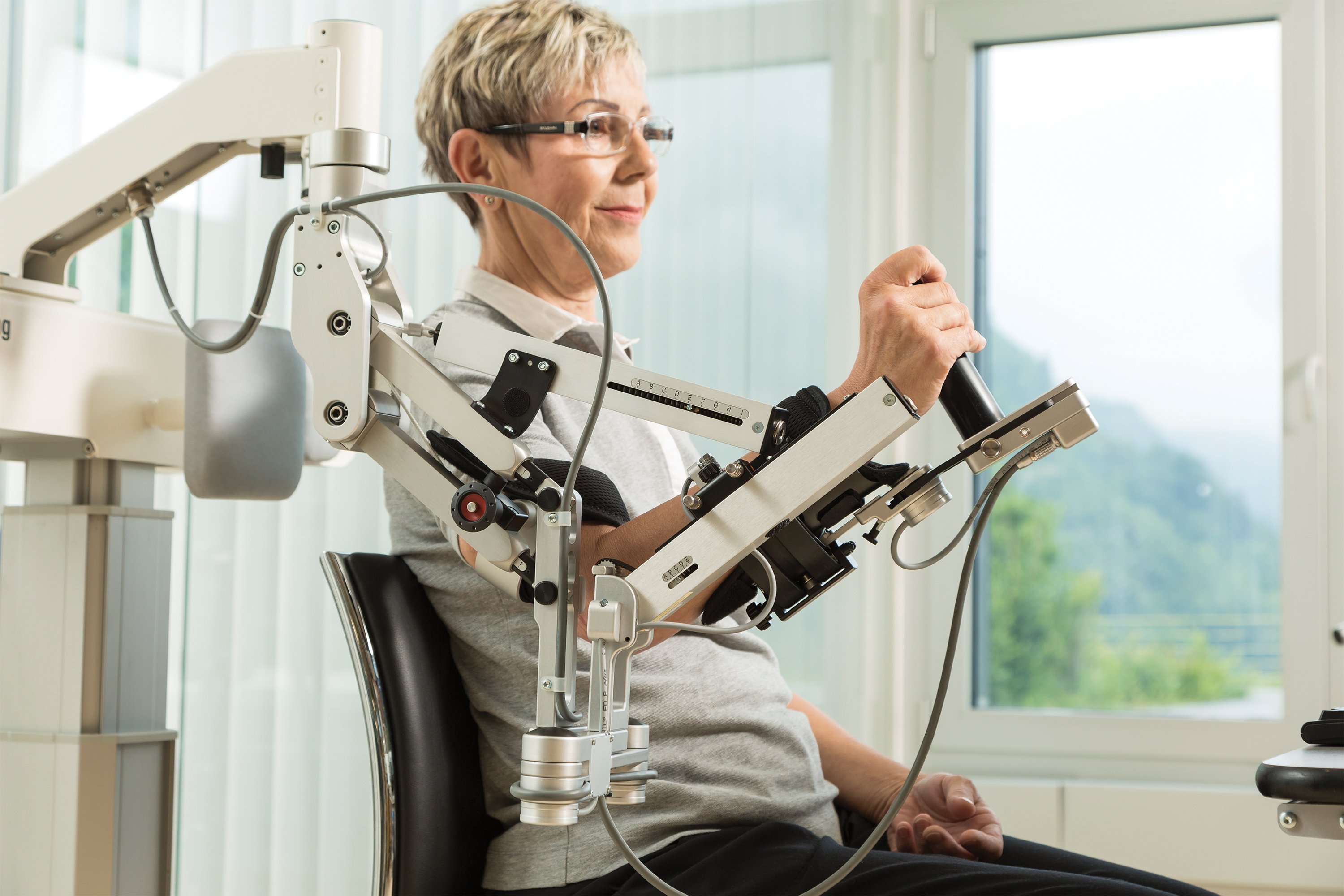 Patient using ArmeoSpring Equipment for Rehabilitation